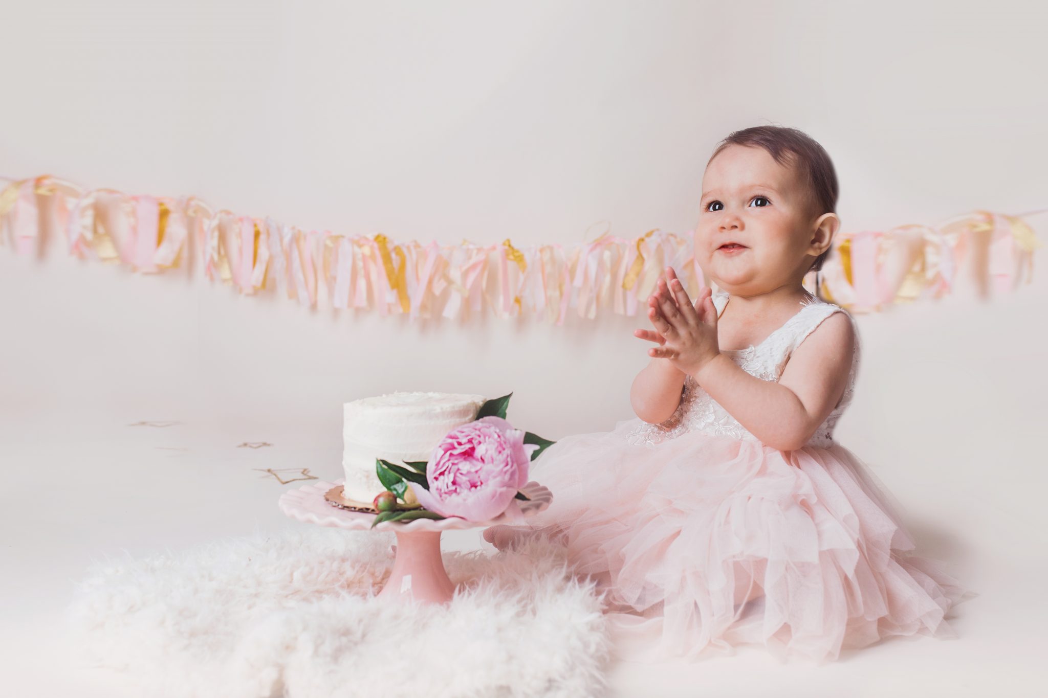 baby girl and pink cake