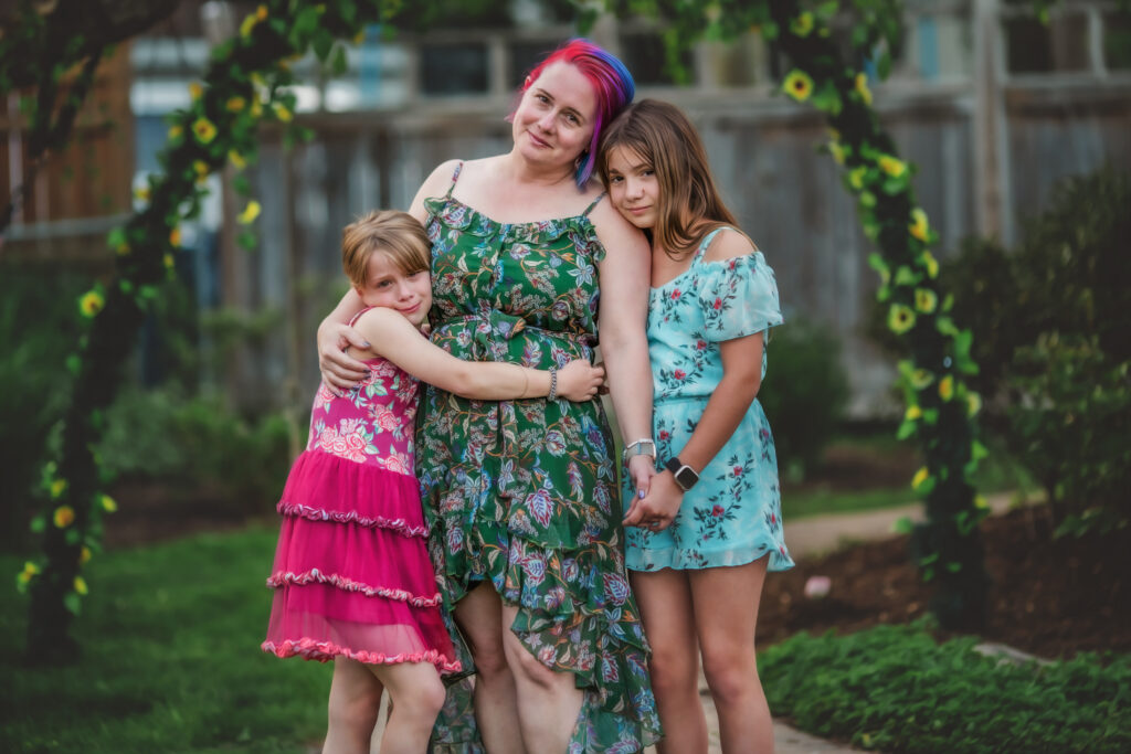 Mom and daughters in backyard